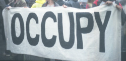 Two photographs of a banner that reads "Occupy Wall Street"