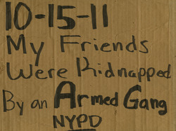 Protest sign calling NYPD an "Armed Gang"